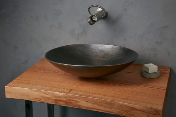 Gray oval basin with modern design tap